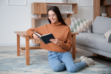 Young woman reading book at home