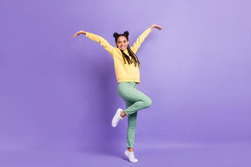 Fototapeta na wymiar Full size photo of hooray cool lady dance wear yellow sweater trousers sneakers isolated on lilac color background