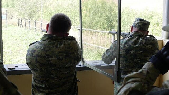 a soldier shoots an automatic pistol with a silencer at targets Russian military army FSB