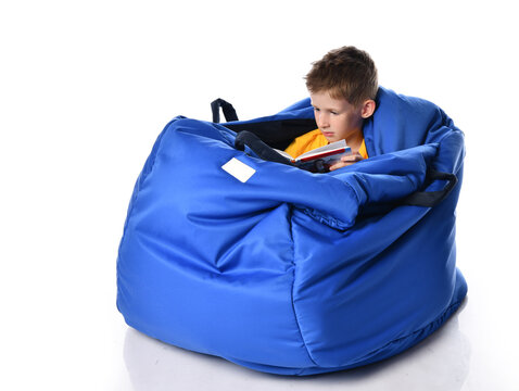 child sits in a unique ball-shaped cocoon for development and sensory integration, rests, reads a book