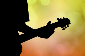 Silhouette of guitar player in concert with purple light - Powered by Adobe