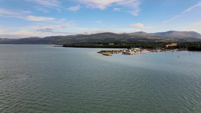 Red Sailing Boats on Menai Strait Next to Beautiful Landscape Of Snowdonia Wales