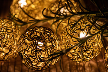 golden colored illuminated lights with tree branches, close up