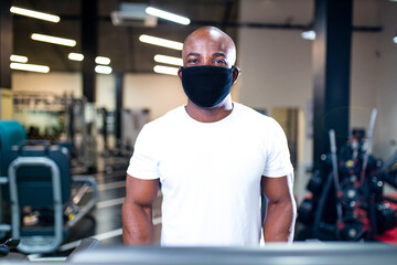 spain man in white cotton t-thirt wearing mask while working out in gym