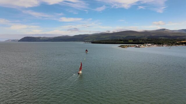 Red Sailing Boats Next to beautiful Snowdonia Landscape Wales