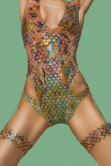 Front view of a woman's body, wearing a fish scale textured pastel color silicone swimsuit, legs apart © ArtMood Visualz