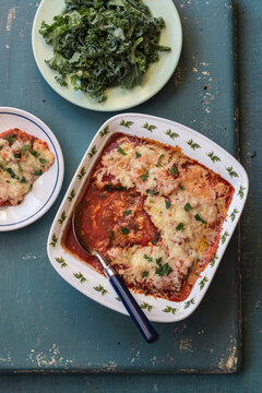 Celeriac parmigiana - celeriac cut into slices, with tomato sauce and cheese, kale, parley