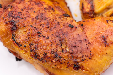 Golden crispy roasted chicken legs with skin macro close up shot