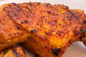 Golden crispy roasted chicken legs with skin macro close up shot