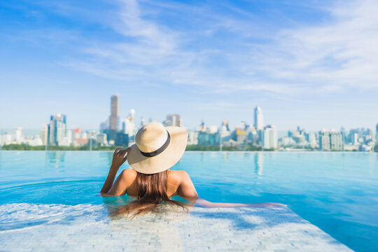 Portrait beautiful young asian woman smile relax leisure around outdoor swimming pool
