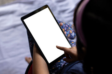 an indian girl child holding tablet with white blank screen in hand