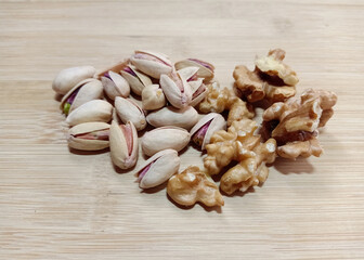 walnuts and pistachios  on wooden background