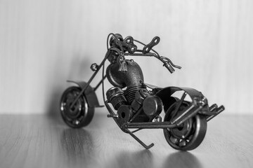 A motorcycle model assembled from household items. A piece of pipe, wire, nuts, etc.