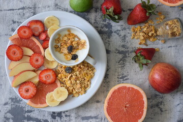 Fototapeta na wymiar Yogurt with seasonal fruits and granola.