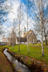 Fototapeta na wymiar View of the Rauma river (canal) and the The Church of the Holy Cross (Pyhan Ristin kirkko), Rauma, Finland