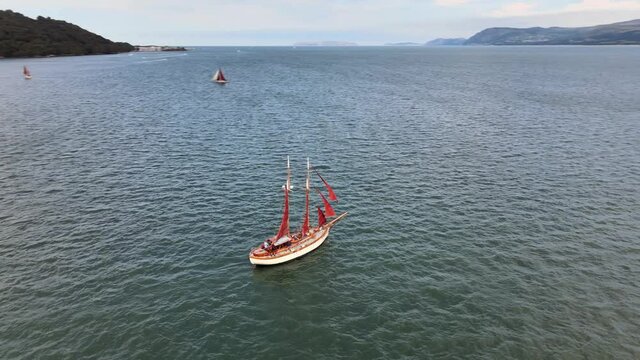 Red Sailing Boat 360 Next to beautiful Snowdonia Landscape Wales