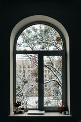 Arch window with snowy view outside. Christmas at home, 2021 new year