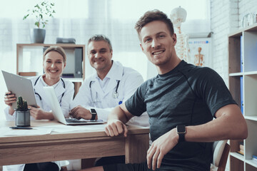 Male and female doctors with stethoscopes. 