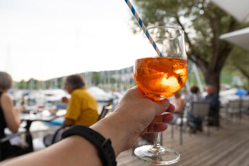 Tourist holding a soft drink during sunset in Neuchatel city, Switzerland, with Neuchatel lake in background, famous tourist destination in Swiss .