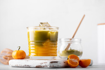 iced green matcha with orange juice in a glass