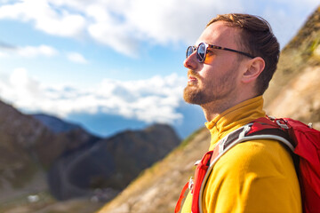 Man on top of mountain. Conceptual scene in fog at sunset