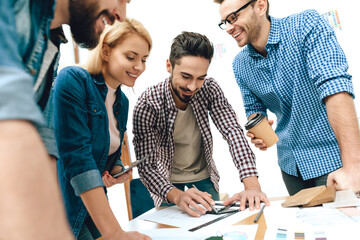 Team of designers architects discuss project.