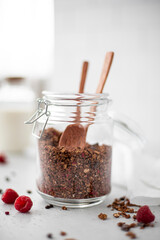 chocolate granola with nuts and seeds in a glass jar