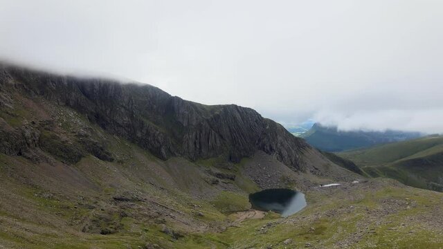 Thick Clouds Covering Majestic Peaks Of Beautiful Mount Snowdon Snowdonia Wales Lake