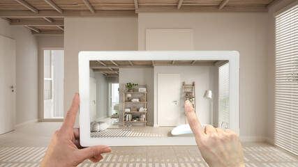 Augmented reality concept. Hand holding tablet with AR application used to simulate furniture and design products in empty interior with ceramic tiles. Bathroom with big round bathtub