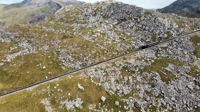 Train Travelling Up Steep Railway In Rocky Mountains Of Mount Snowdon Snowdonia Wales