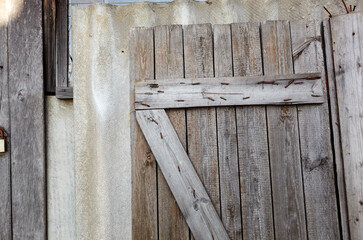 Old wooden removed door on wall. Vintage weathered background