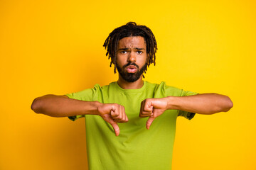 Photo of disappointed dark skin guy show thumb down sign disagree information concept isolated...