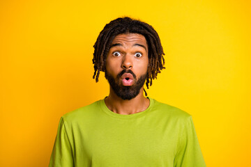 Portrait of impressed dark skin guy shout surprise isolated over vivid yellow color background