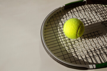 Tennis ball and racket on isolated white background.