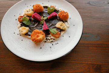 Dessert fried bananas with chocolate and dragon fruits