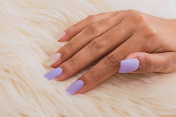 Nail care - Women's hand with light colored nails.