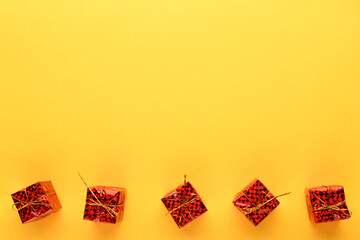 New year's gifts in red on a bright yellow background, on top of the place for the space mine. New year and Christmas background.