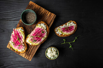 Healthy breakfast toasts from sliced watermelon radish with chinese daikon, cottage cheese and...