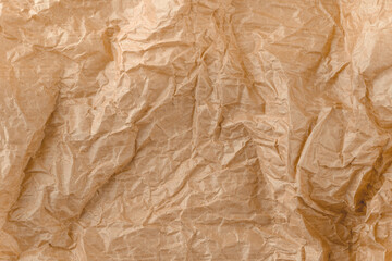 Kraft paper texture. Brown crumpled paper. Crinkled wrap sheet, recycle grunge texture sample. Closeup of parchment canvas.