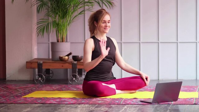 Online sport fitness yoga training workout. woman doing exercises opposite laptop at home. yoga asanas. balance between body and mental development. close up view. Slow motion nvideo. stock footage