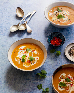 Carrot soup with coconut milk, red chillies, cilantro, white and blach sesame seeds