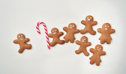 Funny gingerbread man with sugar cane