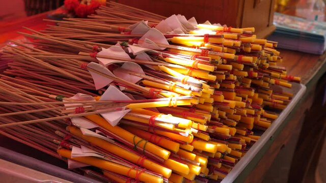 4K Incense joss stick, little candle, gold leaf for worship buddha image in local temple in countryside. Concept of life, hope, belief, buddhism religion.