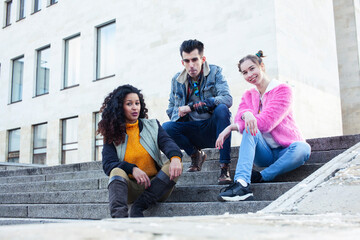 cute group of teenages at the building of university with books huggings, diversity nations real students lifestyle