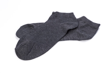 Pair of dark short socks on a white background, top view