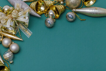 Christmas composition. Gifts, tree branches, golden and silver decorations on green background. Christmas, winter, new year concept. Flat lay, top view, copy space.