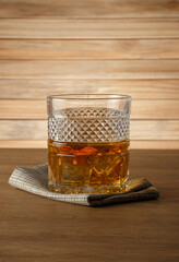 Glass of whiskey on a wooden background