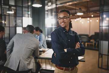 Young businessman smiling while working in a modern office