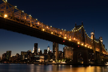 Fototapeta na wymiar The Queensboro Bridge during the Evening with the Manhattan Skyline along the East River in New York City