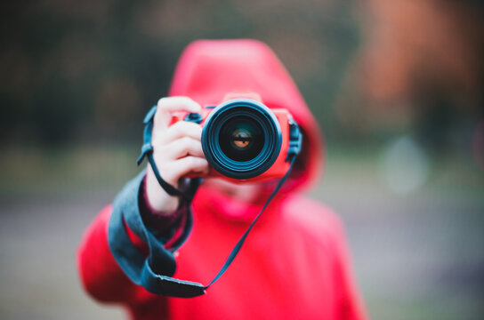 Photographer In Center Taking Photo With Lens And Red Hoodie Rainy Autumn Day